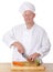 Male chef chopping vegetable on a chopping board