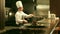 Male Chef is Cooking Flambe in Restaurant Kitchen