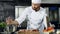 Male chef cooking meat at professional kitchen. Portrait of chef cooking steak.