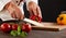 Male chef cutting fresh capsicum or peppers