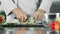 Male chef cutting fresh vegetable. Closeup chef hands slicing cucumber.