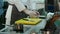 Male chef getting shrimps from container and putting them on a tray