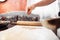 Male chef hand over dough, apple strudel cooking