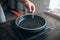 Male chef hands puts rosemary in a frying pan