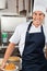 Male Chef Holding Baked Cake In Kitchen