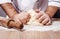 male chef kneads the dough