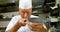 Male chef looking at knife in kitchen 4k