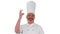 Male chef making real jam gesture to camera on white background.