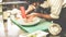 Male chef prepare fish dish for dinner - Man garnishing a starter inside restaurant kitchen - Focus on hands - Exclusive cuisine,