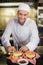 Male chef preparing burger in commercial kitchen