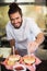 Male chef preparing burger in commercial kitchen