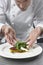 Male Chef Preparing Salad In Kitchen