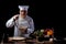 Male chef in a restaurant kitchen wearing white uniform tasting spaghetti with fresh vegetables