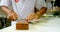 Male chef sharpening knife on a whetstone in kitchen 4k