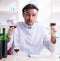 Male chemist examining wine samples at lab