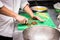 Male chief chopping vegetables for making a dish