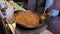 Male chief cook frying delicious spaghetti at the street food-fest. Gastronomy