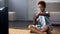 Male child playing on video game console home, sitting floor, gadget addiction