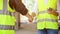 Male civil engineer shaking hand with male construction inspector. cropped