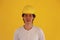 Male civil engineer with yellow helmet and wear white T-shirt on yellow background