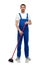 male cleaner in overall cleaning floor with broom