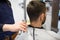 Male client and barber cleaning hair from neck