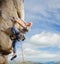 Male climber climbing big boulder in nature with rope