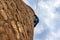 A male climber climbs a brick water tower