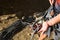 A male climber ties a safety knot eight on the harness before climbing the track. Climbing equipment: rope, quickdraw, safety