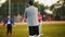 Male coaching kids during practice at Baseball Field