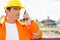 Male construction worker communicating on walkie-talkie at site