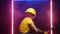 A male construction worker in a hard hat hits with a sledgehammer