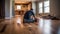 Male construction worker installing laminate timber flooring in new flat. Home renovation concept