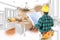 Male Contractor with Hard Hat and Plans Looks At Custom Kitchen