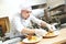 Male cook chef decorating food on the plate