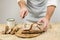 Male cook cuts bread.