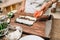 Male cook making sushi on wooden table, asian food