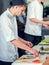 Male cooks preparing sushi