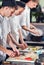 Male cooks preparing sushi