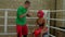 Male cornerman giving instructions to black female fighter inside boxing ring