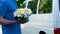 Male courier delivering flowers to client, express shipment to your family fest