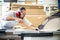 Male craftsman saws wood on a circular saw