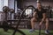 Male crossfit athlete working out with battle ropes at gym