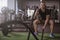 Male crossfit athlete working out with battle ropes at gym