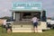 Male customer at a fish and chips vendor stall outside buying hot food