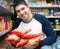 male customer looking at assortment of pasta and smiling