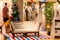Male customer near the white sofa on striped rug at IKEA showroom on Christmas season