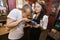 Male customer smelling coffee beans while salesperson holding bowl in store