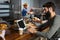 Male customer using laptop while having coffee at counter