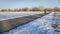 male cyclist commuting on a bike trail in winter scenery - Poudre River Trail in northern Colorado